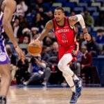 New Orleans Pelicans guard Dejounte Murray (5) brings the ball up court against Sacramento Kings guard De'Aaron Fox (5